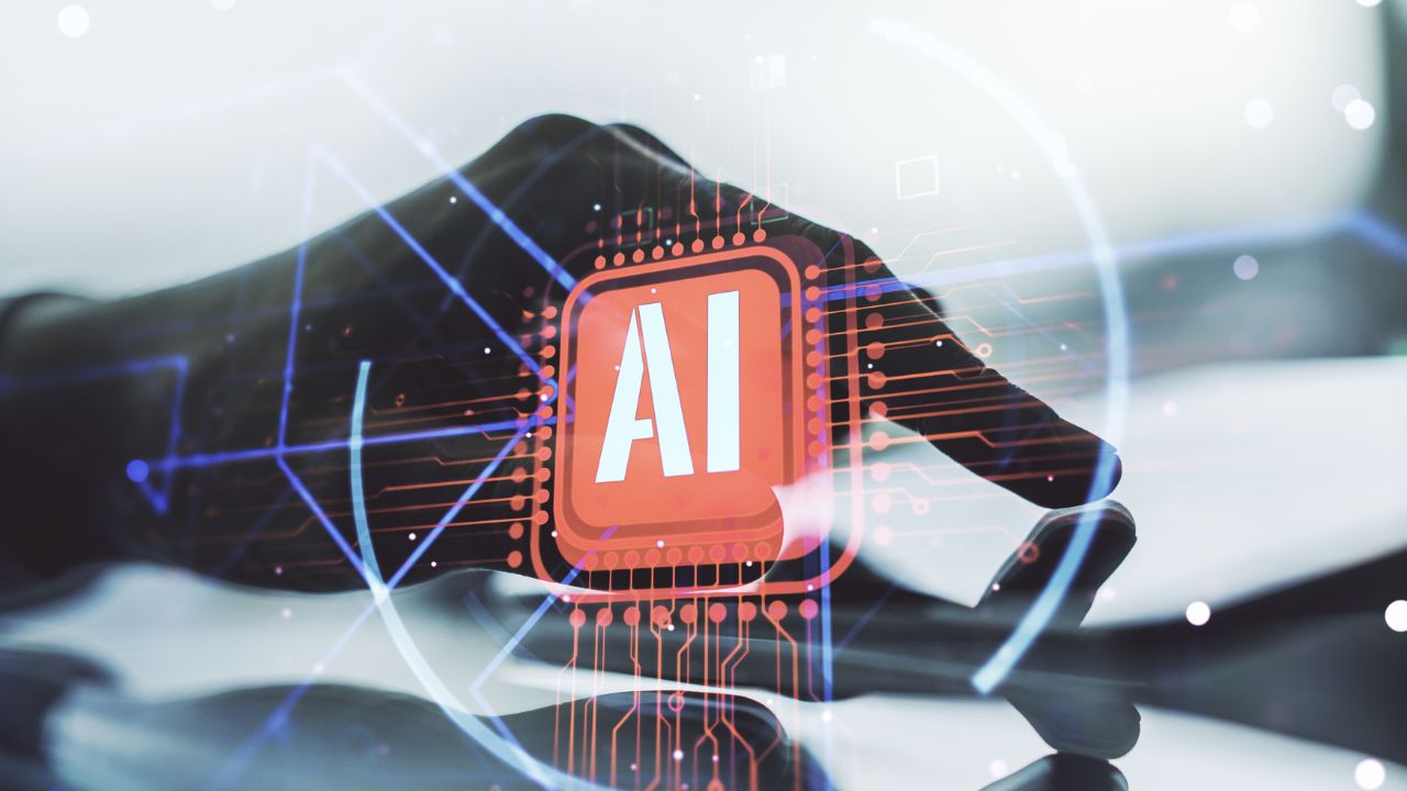 close-up of a person interacting with a digital interface displaying the letters 'ai,' highlighting how aiOS can help mitigate ai implementation risks