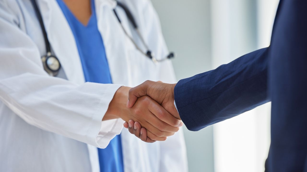 Medical and business professionals shaking hands