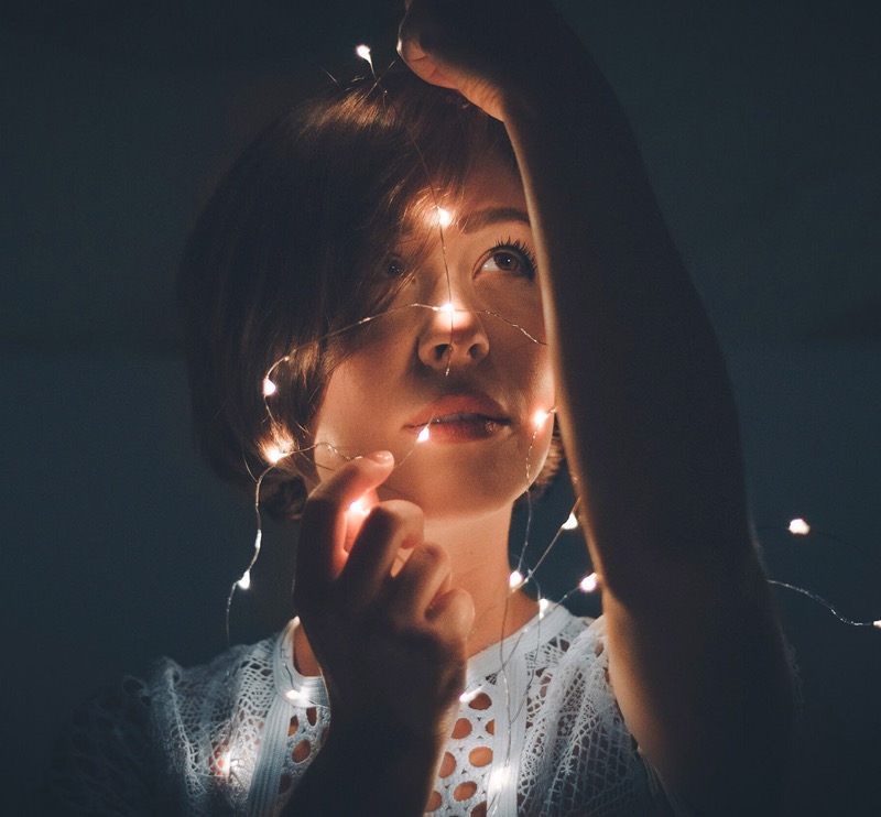 A woman with light in her hands