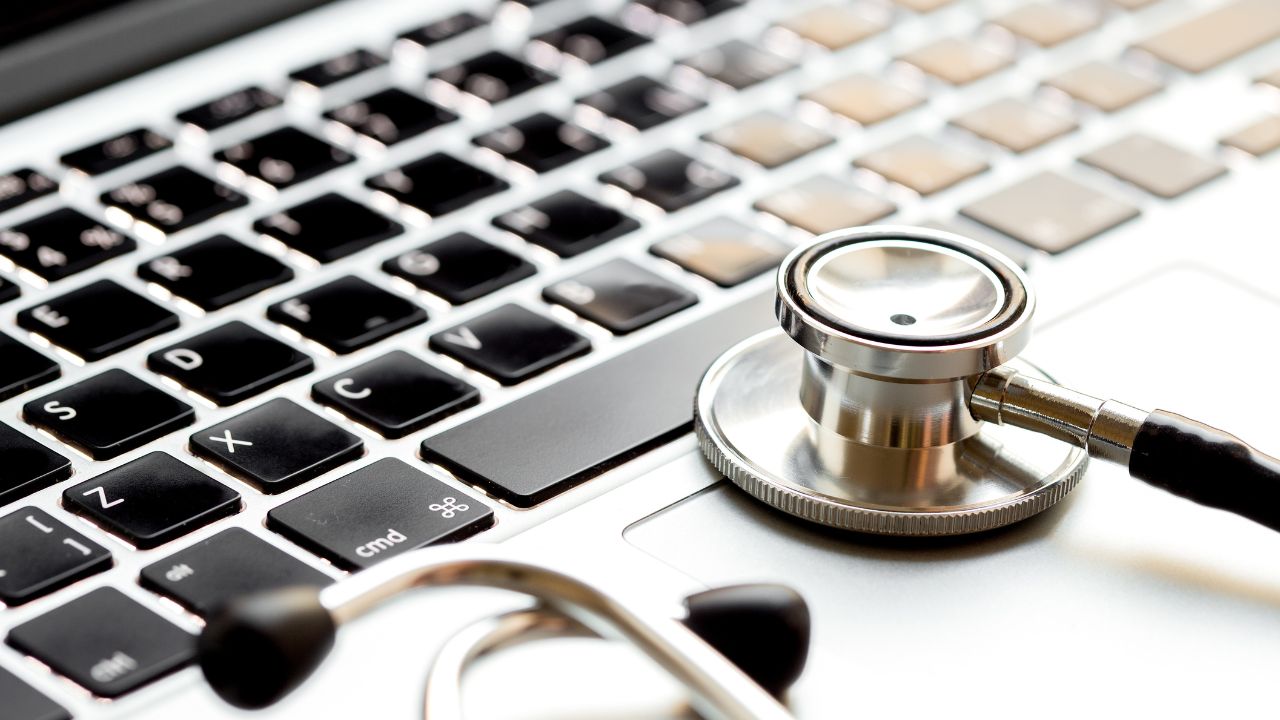 Stethoscope sitting on top of a laptop keyboard