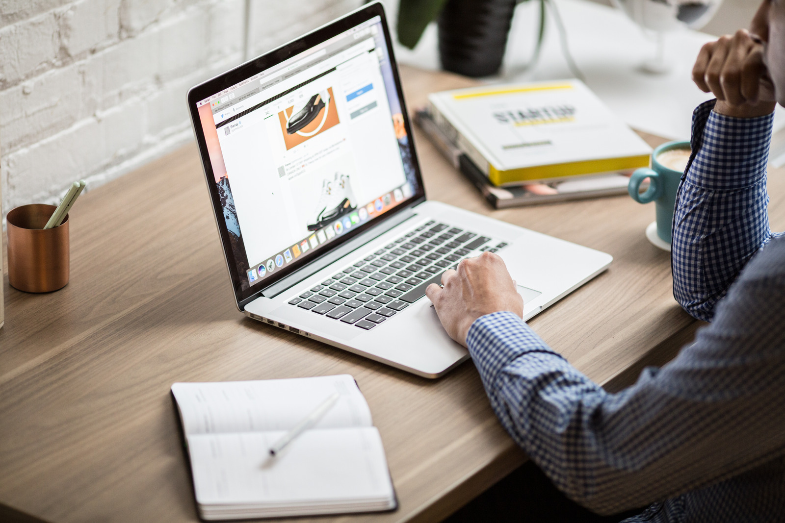 A man sitting at a desk on his computer