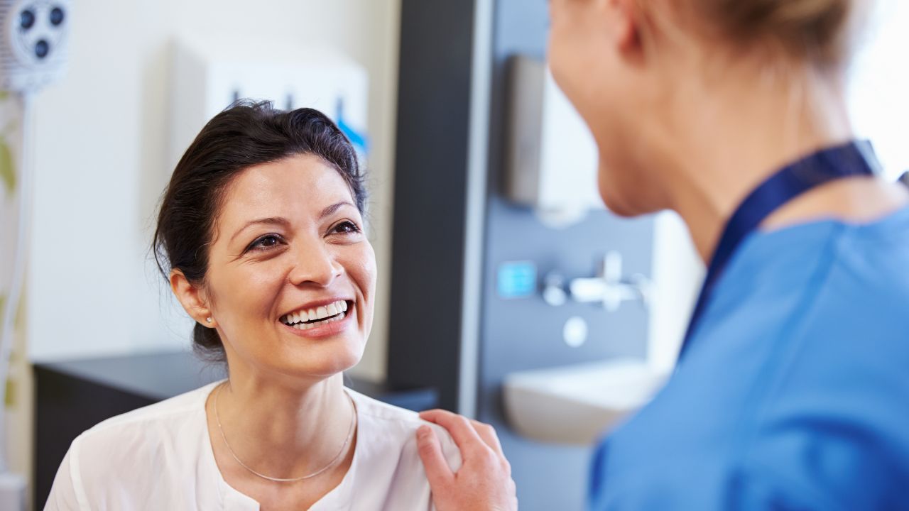 Woman talking to a medical professional and smiling