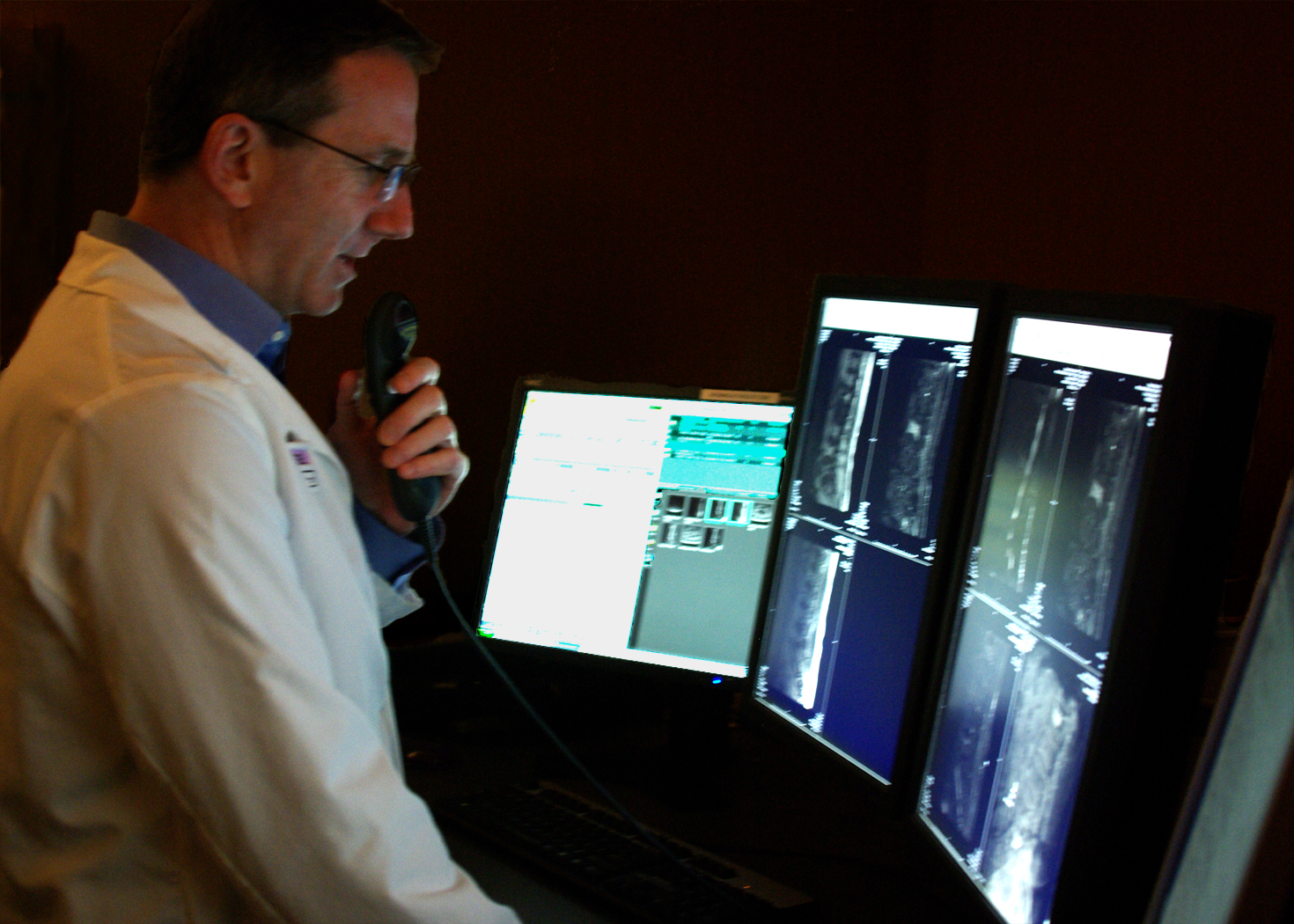 A radiologist looking at scans