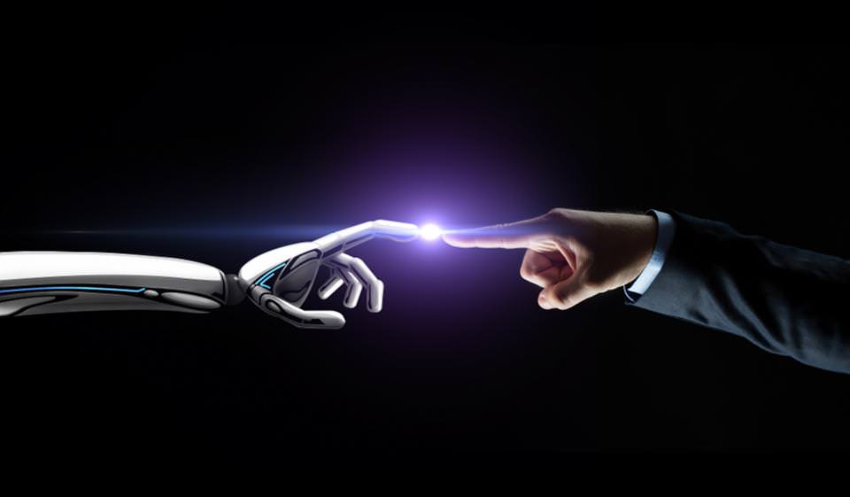 A robots finger touching a human finger